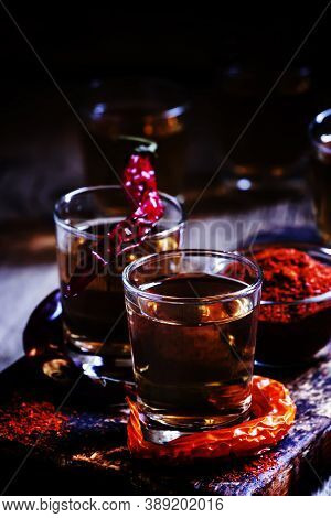 Pepper Vodka, Dark Vintage Wooden Background, Selective Focus
