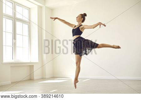 Slender Young Woman Dancing In Studio, Practicing Fouette Jumps, Getting Ready For The Show