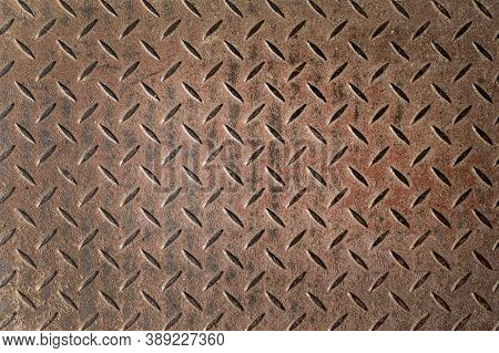 Abstract Background Of Old Rusty Diamondplate Rusty Metal Panel. Grunge Brown Rough Grip Industrial 