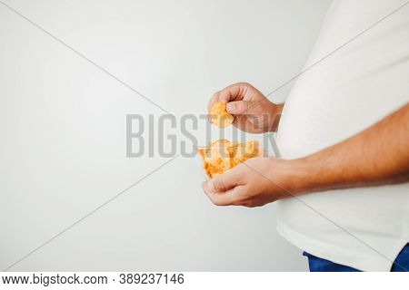 Fast Food, Processed Food, Unhealthy Diet, Imbalanced Ration. Overweight Man Eating Salted Fattening