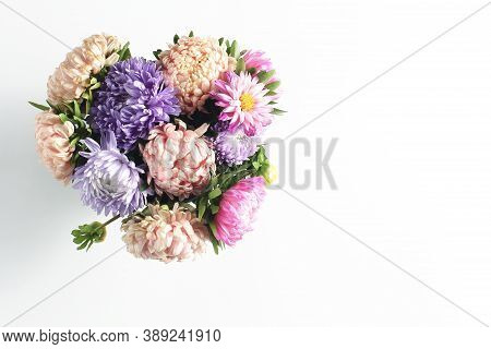 Beautiful Autumn Bouquet Of Asters On A White Background. Simple Flat Composition With Place For Tex