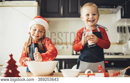 Happy Bother And Sister Cooking Something In The Kitchen While Prepare For The Xmas Holidays Wearing