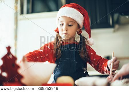Caucasian Girl Is Preparing Food For Christmas Holidays Wearing Santa Clothes And Hat