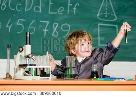 Back To School. Pupil Looking Through Microscope . Student Do Science Experiment With Microscope In 