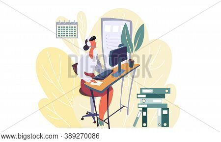 Female Employee In Headphones Is Sitting At The Desk And Working On The Computer While Looking At Th