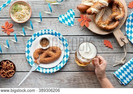 Celebrating Oktoberfest. Traditional Food And German Beer, Top View On Wooden Table,