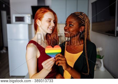 Cheerful Afro And European Lesbian Women At Home On The Bed