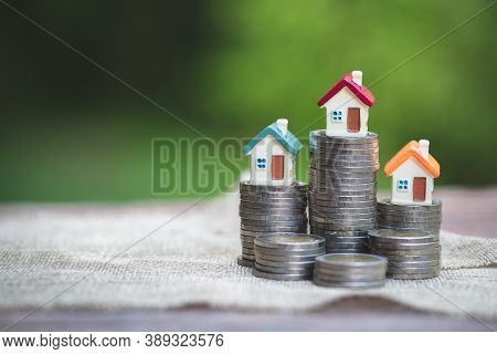 Mini House On Stack Of Coins,money And House,  Mortgage, Savings Money For Buy House And Loan To Bus