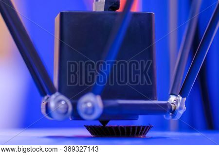 Print Head Of 3d Printer Machine Printing Plastic Model Against Blue Background At Modern Scifi Tech