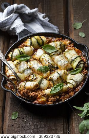 Baked Zucchini Rolls With Ricotta Cheese And Herbs In Meat Ragu Bolognese And Basil