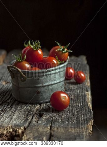 Home Grown Cherry Tomatoes In An Old Metal Bowl On An Old Metal Bowl