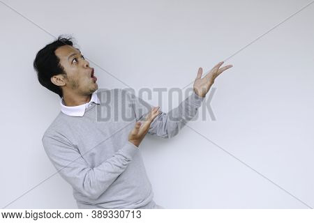 Young Asian Man Waer White Shirt Is Surprised And Shouting Wow With Pointing Right With His Finger I