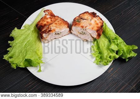 Cutlet On A Black Wooden Background. Chicken Kiev Made In Russia. Patty With Stuffing, Breaded With 