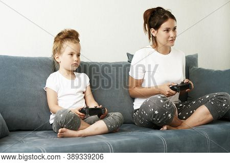 Mother And Daughter Are Playing Computer Game. Mother And Daughter Spend Time Together.