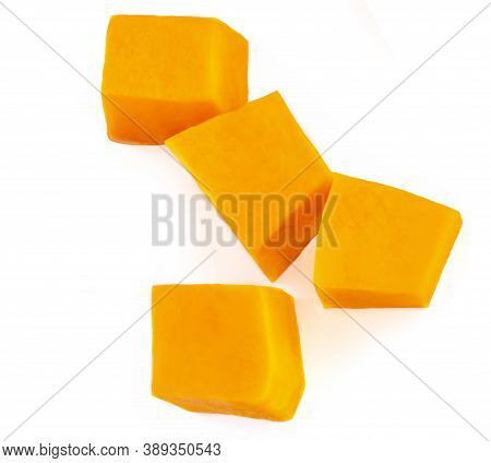 Diced Pumpkin  Isolated On White Background.  Fresh Pumpkin Pieces Cut In A Cube Slice, Top View. Fl