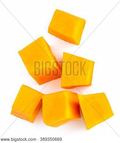 Diced Pumpkin  Isolated On White Background.  Fresh Pumpkin Pieces Cut In A Cube Slice, Top View. Fl