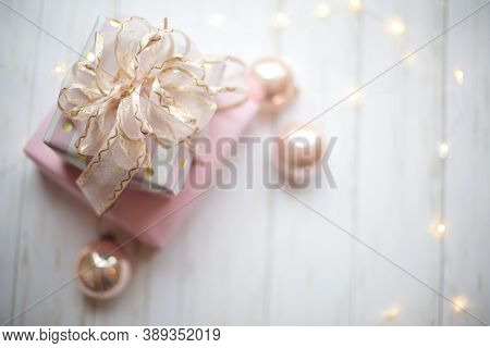 pink gifts on wooden tables for Christmas celebrations