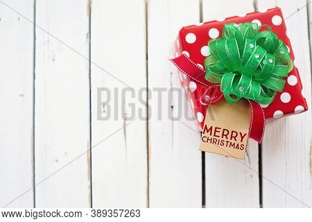 gift with ribbon and Christmas greeting card on the table for Christmas celebration