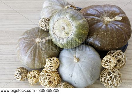 Still Life With Pumpinks And Starw Balls On A Wooden Table