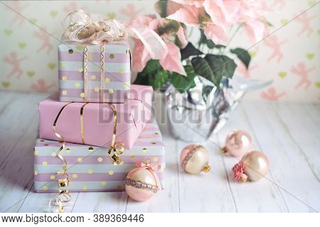 three gifts, plants and Christmas ornaments on the table for the celebration of Christmas