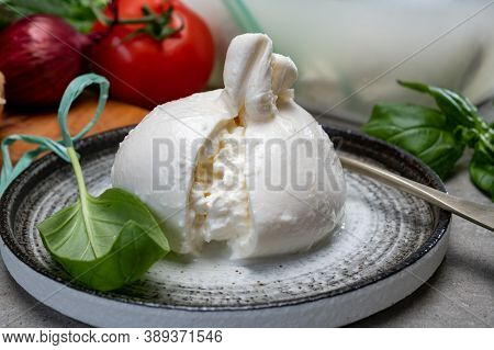 Eating Of Fresh Handmade Soft Italian Cheese From Puglia, White Balls Of Burrata Or Burratina Cheese