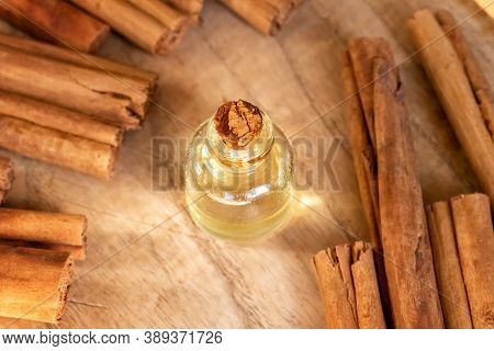 A Bottle Of Essential Oil With Ceylon Cinnamon Sticks On A Table