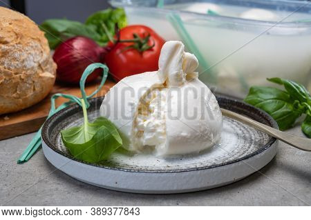 Eating Of Fresh Handmade Soft Italian Cheese From Puglia, White Balls Of Burrata Or Burratina Cheese