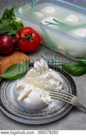 Eating Of Fresh Handmade Soft Italian Cheese From Puglia, White Balls Of Burrata Or Burratina Cheese