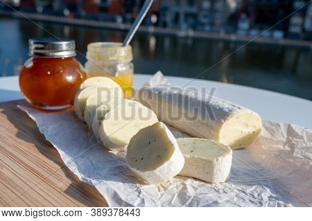 Belgian Abbey Cheese Fagotin In Pieces With Jam Served Outdoor With View On Maas River And Center Of