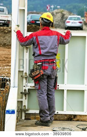 construction worker at a building formwork for concrete work. construction of an industrial building
