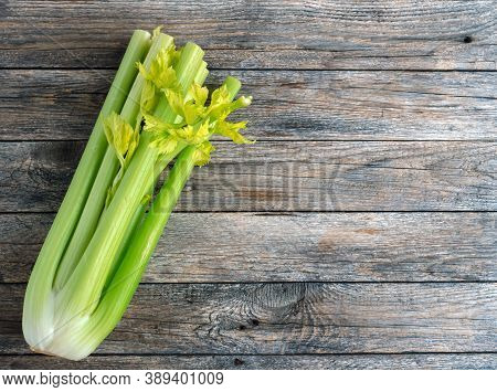 Bunch Of Fresh Celery Stalk With Leaves On Rustic Wooden Background. Organic Celeriac. Healthy And V