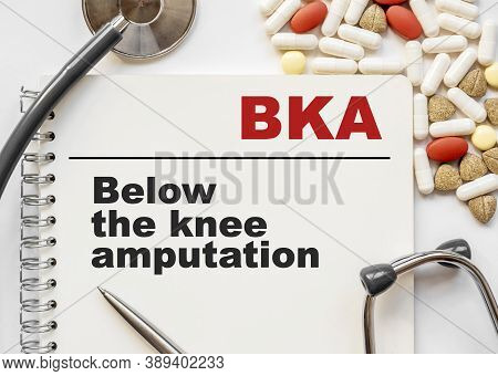 Page In Notebook With Bka Below The Knee Amputation. On White Background With Stethoscope And Group 