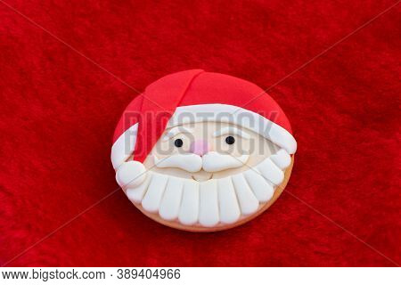 Christmas Cookies With Santa Face On Red Fur Background 