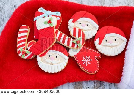 Christmas Cookies With Santa Face On Red Fur Background 