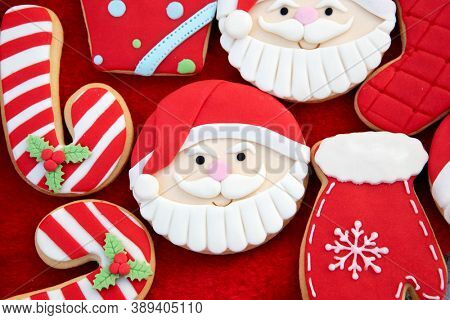 Christmas Cookies With Santa Face On Red Fur Background 