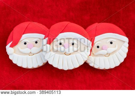 Christmas Cookies With Santa Face On Red Fur Background 