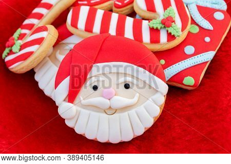 Christmas Cookies With Santa Face On Red Fur Background 
