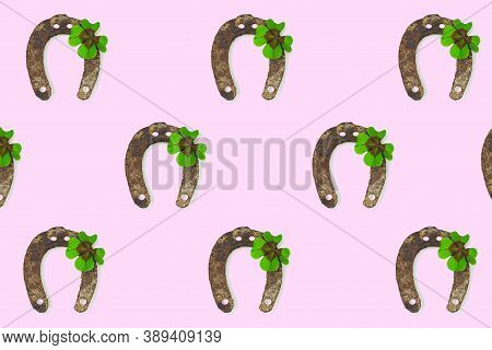 Horseshoe And Shamrock Repeated Pattern. Horseshoe And Four-leaf Clover Isolated On Pink Background.