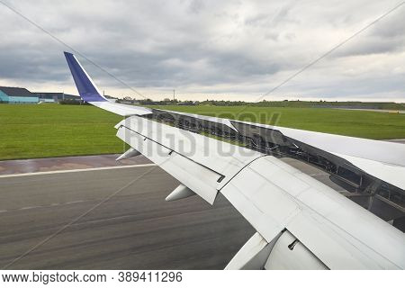 Airplane wing with flaps and spoilers fully extended to slow down the aircraft after landing