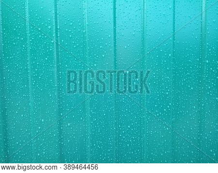 Raindrops On A Green Painted Metal Surface