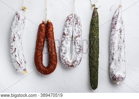 Traditional Dry Cured Sausages Meat Hanging On White Textured Background
