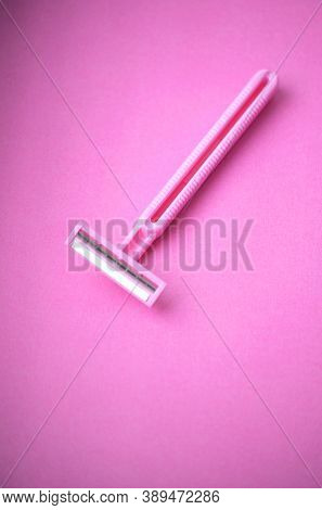 Isolated Pink Plastic Female Razor For Single Use On A Same Pink Background. Copy Space.