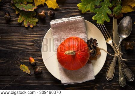 Autumn Table Setting With Craft Plate, Silverware And Fall Decorations. Dark Wooden Table, Toned Ima