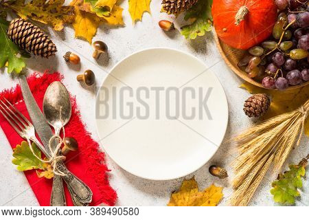 Autumn Table Setting With Craft Plate, Silverware And Fall Decorations At White Table. Thanksgiving 