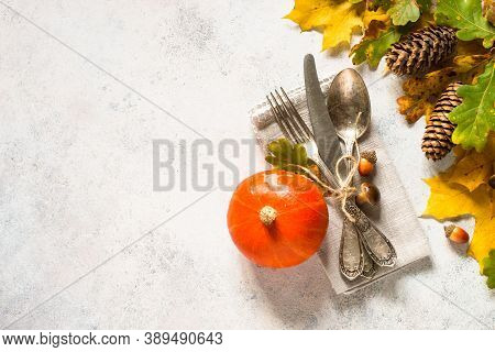 Fall Table Setting With Silverware And Fall Decorations At White Table. Top View With Copy Space.