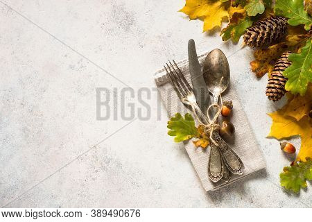 Fall Table Setting With Silverware And Fall Decorations At White Table. Top View With Copy Space.