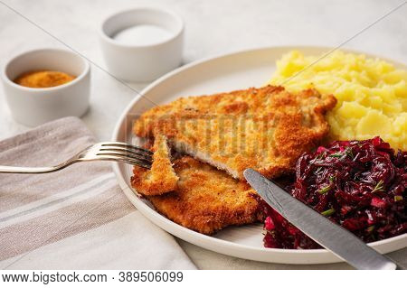 Chop Pork Cutlets , Served With Mashed Potatoes And Beetroot Salad.
