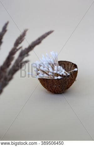 Wooden Ear Sticks In A Coconut Cup. Zero Waste Concept