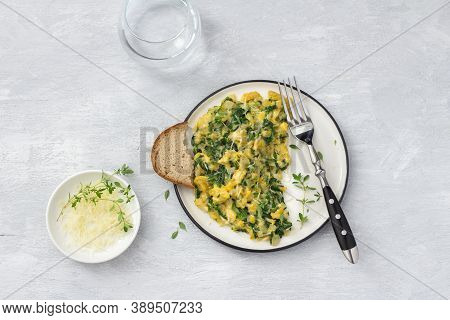 Scrumble Eggs With Kale And Cheese On A Light Gray Background, Top View. Delicious Homemade Breakfas