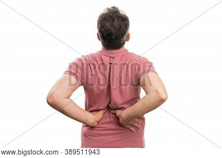 Adult Man With Strained Back Muscular Pain Touching Lumbar Region Wearing Casual Summer Tshirt Isola